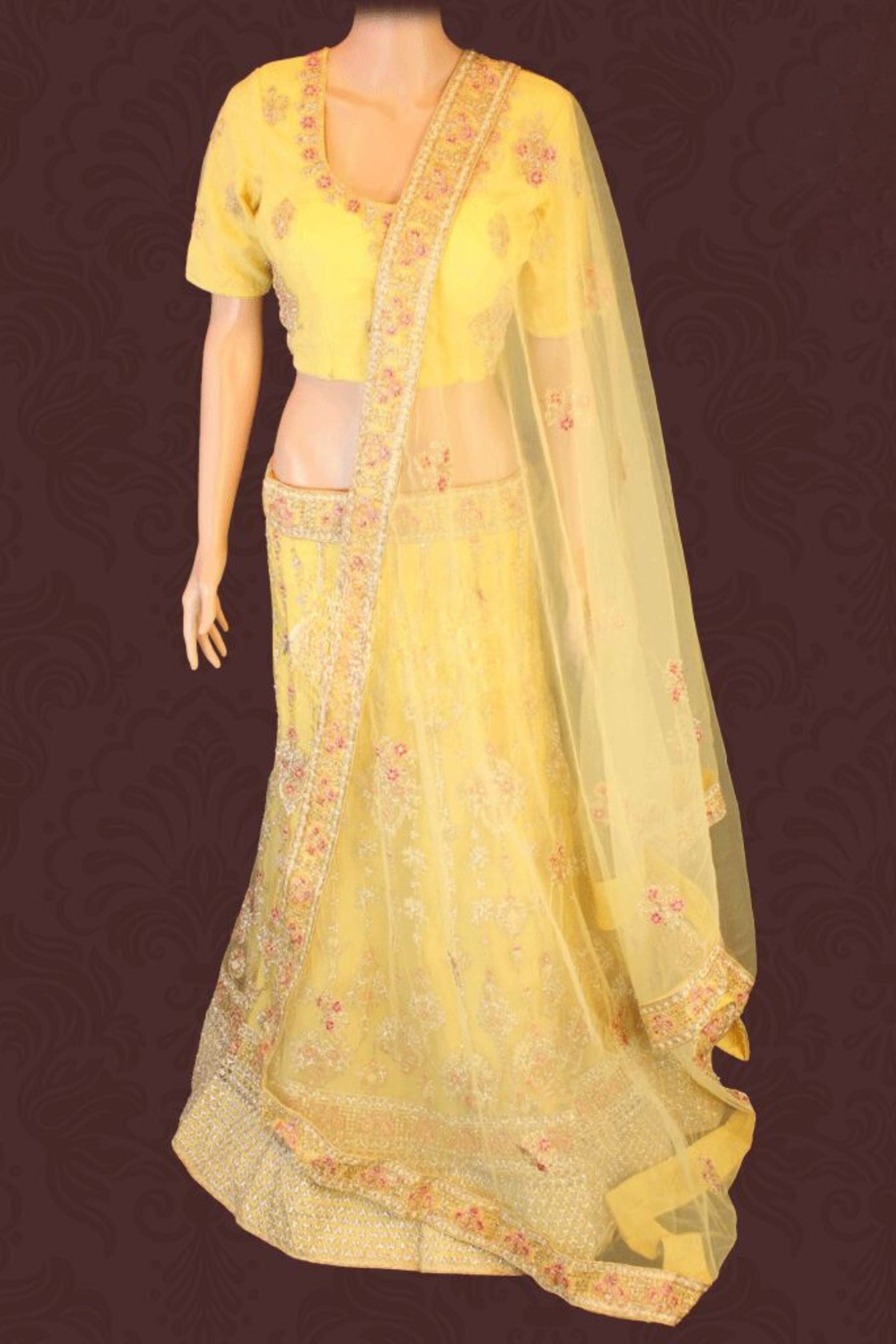 Heavy designer lehenga with embroidery & stone work in a pleasant yellow